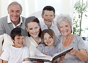 Smiling family looking at a photograph album