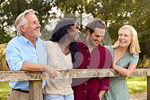 Smiling Family With Mature Parents And Adult Offspring On Walk In Countryside