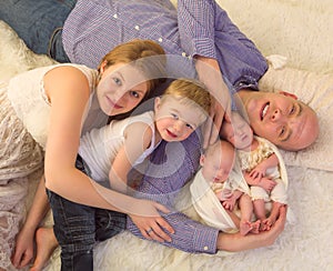 Smiling family with newborn twins