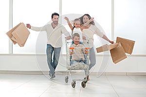 Smiling family with shopping cart
