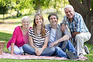 Smiling family sitting on a blanket