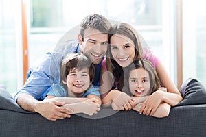 Smiling family on sofa