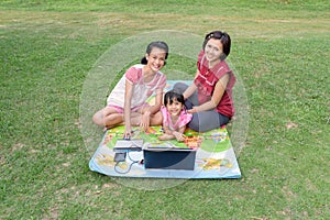 Smiling family using laptop outdoor