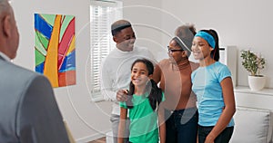 Smiling family is viewing apartment for rent sale parents are embracing their children they are listening attentively to