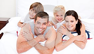 Smiling family waching television