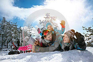 Smiling family on winter vacation - Ski, snow, sun and fun