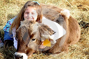 Smiling farm girl and pet calf
