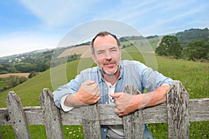 Smiling farmer by the fence photo