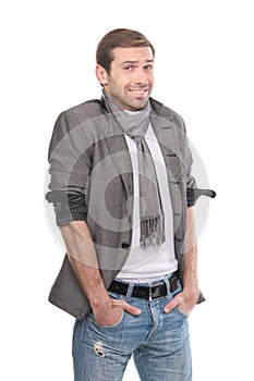 Smiling fashionable man wearing a scarf and gray clothes