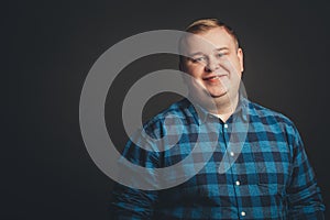 Smiling fat man on black background