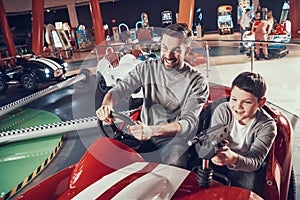 Smiling father and son in amusement center