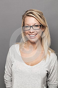 Smiling female blond student expressing wellbeing at studying