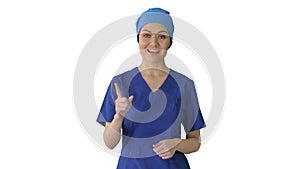 Smiling female in blue medical uniform advertising clinic servic