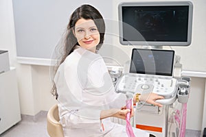 Young doctor sitting near equipment in the hospital