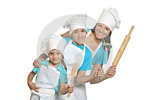 Smiling female chef with assistants