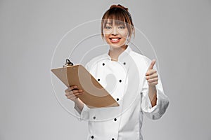 smiling female chef with clipboard