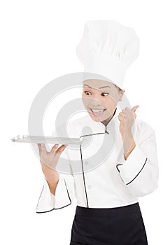 Smiling female chef, cook or baker showing thumbs up