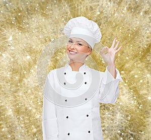 Smiling female chef showing ok sign