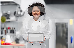 smiling female chef showing tablet pc on kitchen