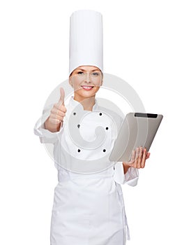 Smiling female chef with tablet pc computer