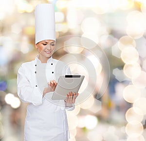 Smiling female chef with tablet pc computer