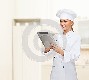 Smiling female chef with tablet pc computer