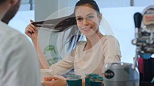 Smiling female client flirting with bartender at bar counter in cafe