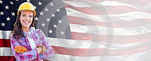 Smiling Female Contractor Wearing Blank Yellow Hardhat and Gloves Over Waving American Flag Background Banner