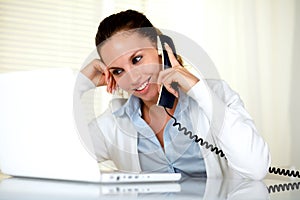 Smiling female conversing on phone