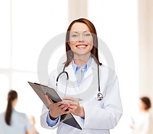Smiling female doctor with clipboard