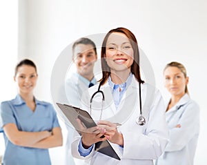 Smiling female doctor with clipboard