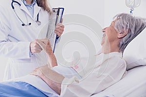 Smiling female doctor comforting a patient