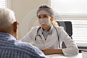 Smiling female doctor consult elderly male patient in clinic