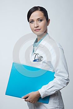 Smiling female doctor with file