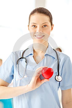 Smiling female doctor with heart an stethoscope