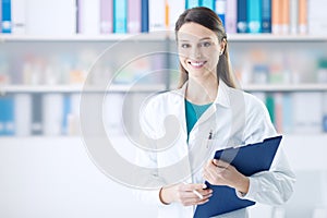 Smiling female doctor holding a clipboard