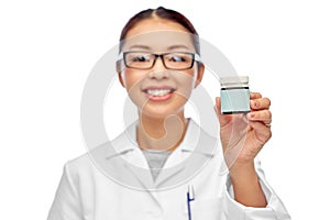 smiling female doctor holding jar of medicine
