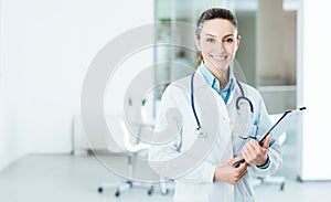 Smiling female doctor holding medical records photo