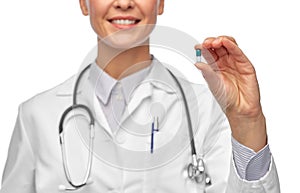 smiling female doctor holding medicine pill