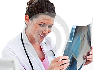 Smiling female doctor looking at X-ray