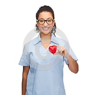 Smiling female doctor or nurse with heart