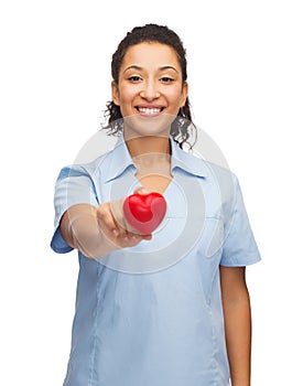 Smiling female doctor or nurse with heart