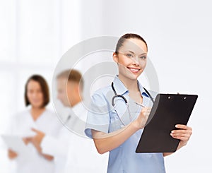 Smiling female doctor or nurse with stethoscope