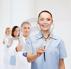 Smiling female doctor or nurse with stethoscope