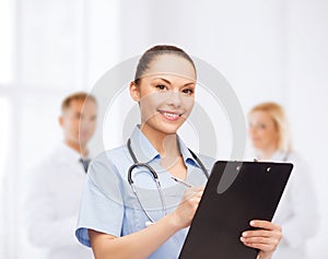 Smiling female doctor or nurse with stethoscope