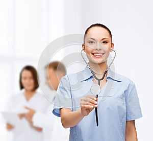 Smiling female doctor or nurse with stethoscope