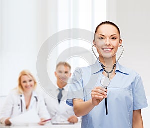 Smiling female doctor or nurse with stethoscope