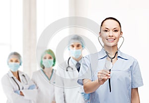 Smiling female doctor or nurse with stethoscope