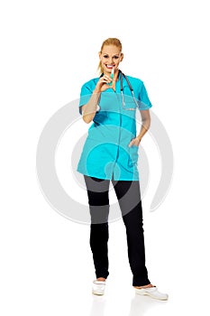 Smiling female doctor or nurse with stethoscope holding syringe