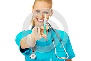 Smiling female doctor or nurse with stethoscope holding syringe